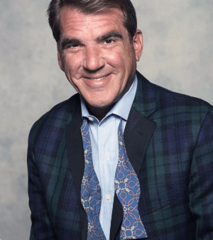 A man wearing a suit and tie smiling at the camera - Marc Eisenchteter